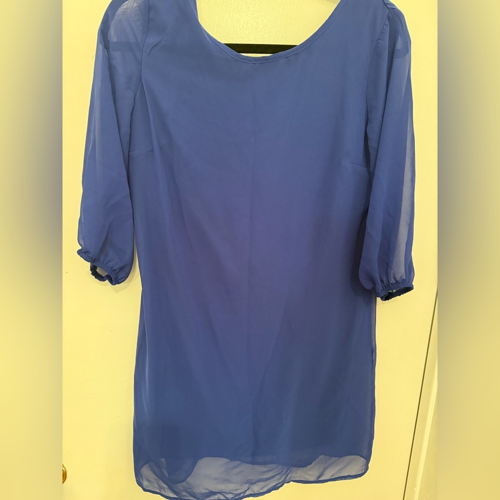 Sheer blue evening or dinner bow tie back dress